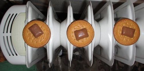 three cookies with a bit of chocolate meltin on the heater